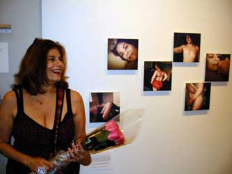 Miss V views Ying Ang photos at ICP end of year show.